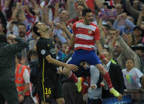Atletico de Madrid s Forward number 9 David Villa Sanchez - VILLA (33 years) - FC Barcelona s Midfielder number 16 Sergio Busquets i Burgos - S. BUSQUETS (26 years) Round quarter-finals of the Champions league, soccer match between Atletico de Madrid - FC Barcelona at the Vicente Calderon estadium, Madrid - Spain by April 9, 2014. 