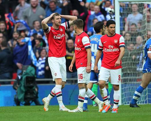 Arsenal s Per Mertesacker looks on dejected after conceding a penalty Wigan Athletic vs Arsenal- FA Cup Semi Final, Wembley Stadium - London - England - 12 04 2014 - Pic David Klein Sportimage EDITORIAL USE ONLY. No use with unauthorised audio, video, data, fixture lists, club league logos or live services. Online in-match use limited to 120 images, no video emulation. No use in betting, games or single club league player publications.