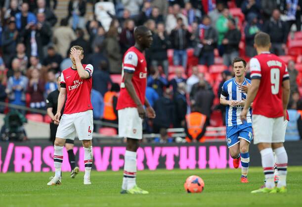 Arsenal s Per Mertesacker looks on dejected after conceding a penalty Wigan Athletic vs Arsenal- FA Cup Semi Final, Wembley Stadium - London - England - 12 04 2014 - Pic David Klein Sportimage EDITORIAL USE ONLY. No use with unauthorised audio, video, data, fixture lists, club league logos or live services. Online in-match use limited to 120 images, no video emulation. No use in betting, games or single club league player publications.