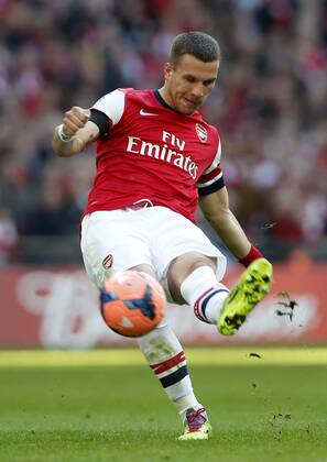Lukas Podolski of Arsenal shoots a free kick during FA Cup semifinal match between Arsenal and Wigan Athletic at Wembley Stadium in London, Britain, on April 12, 2014. Arsenal advanced to the final with winning 4-2 on penalties after a 1-1 draw. (Xinhua Wang Lili) FOR EDITORIAL USE ONLY. NOT FOR SALE FOR MARKETING OR ADVERTISING CAMPAIGNS. NO USE WITH UNAUTHORIZED AUDIO, VIDEO, DATA, FIXTURE LISTS, CLUBLEAGUE LOGOS OR LIVE SERVICES. ONLINE IN-MATCH USE LIMITED TO 45 IMAGES, NO VIDEO EMULATION. NO USE IN BETTING, GAMES OR SINGLE CLUBLEAGUEPLAYER PUBLICATIONS. (SP)BRITAIN-LONDON-SOCCER-FA CUP-ARSENAL VS WIGAN 