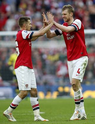 Per Mertesacker (R) of Arsenal celebrates scoring with Aaron Ramsey during FA Cup semifinal match between Arsenal and Wigan Athletic at Wembley Stadium in London, Britain, on April 12, 2014. Arsenal advanced to the final with winning 4-2 on penalties after a 1-1 draw. (Xinhua Wang Lili) FOR EDITORIAL USE ONLY. NOT FOR SALE FOR MARKETING OR ADVERTISING CAMPAIGNS. NO USE WITH UNAUTHORIZED AUDIO, VIDEO, DATA, FIXTURE LISTS, CLUBLEAGUE LOGOS OR LIVE SERVICES. ONLINE IN-MATCH USE LIMITED TO 45 IMAGES, NO VIDEO EMULATION. NO USE IN BETTING, GAMES OR SINGLE CLUBLEAGUEPLAYER PUBLICATIONS. (SP)BRITAIN-LONDON-SOCCER-FA CUP-ARSENAL VS WIGAN 