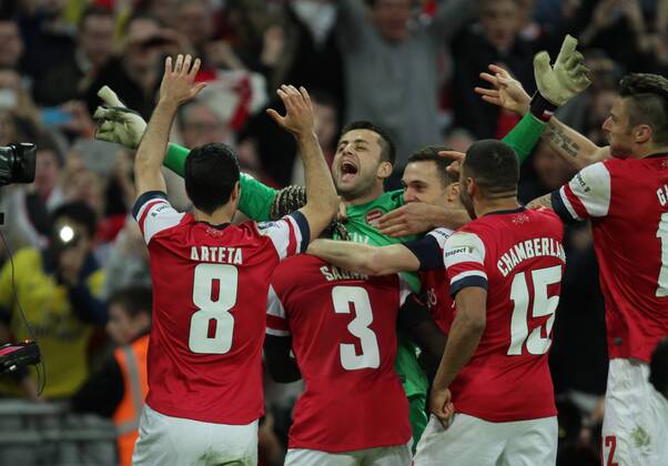 FA Cup SemiFinal - FC Arsenal London v Wigan Athletic . . Wembley, London, UK . . 12.04.2014 Lukasz Fabianski (A) is mobbed after his saves helped to win the penalty shoot-out. 