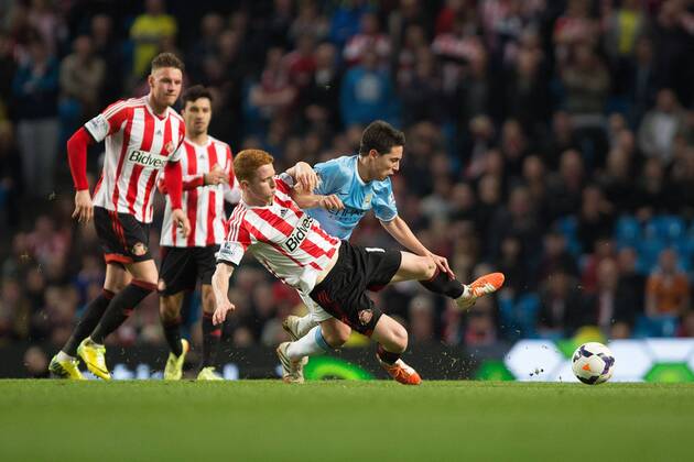 Jack Colback of Sunderland challenges Samir Nasri of Manchester City - Barclays Premier League - Manchester City vs. AFC Sunderland FC - Etihad Stadium - Manchester - England - 16th April 2014 - EDITORIAL USE ONLY. No use with unauthorised audio, video, data, fixture lists, club league logos or live services. Online in-match use limited to 120 images, no video emulation. No use in betting, games or single club league player publications.