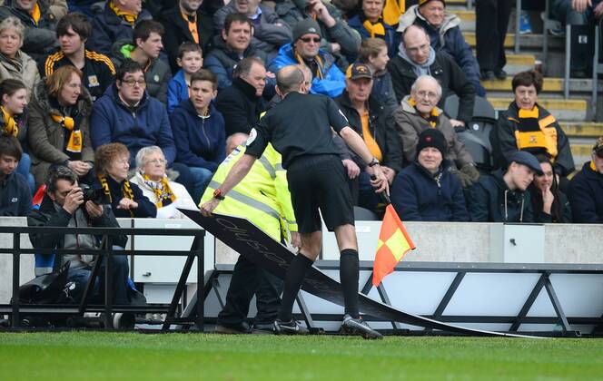 An assistant referee moves an ad board to the side of the pitch - Barclays Premier League - Hull City v Arsenal - KC Stadium - Hull - England - 20th April 2014 - Pic Simon Bellis Sportimage EDITORIAL USE ONLY. No use with unauthorised audio, video, data, fixture lists, club league logos or live services. Online in-match use limited to 120 images, no video emulation. No use in betting, games or single club league player publications.