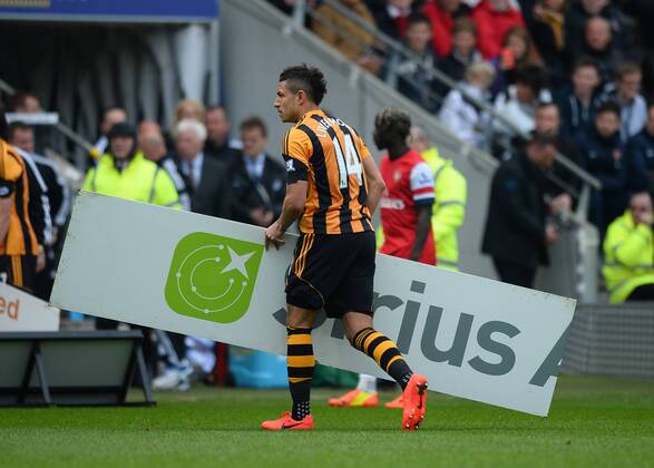 Jake Livermore of Hull City removes an ad board - Barclays Premier League - Hull City v Arsenal - KC Stadium - Hull - England - 20th April 2014 - Pic Simon Bellis Sportimage EDITORIAL USE ONLY. No use with unauthorised audio, video, data, fixture lists, club league logos or live services. Online in-match use limited to 120 images, no video emulation. No use in betting, games or single club league player publications.