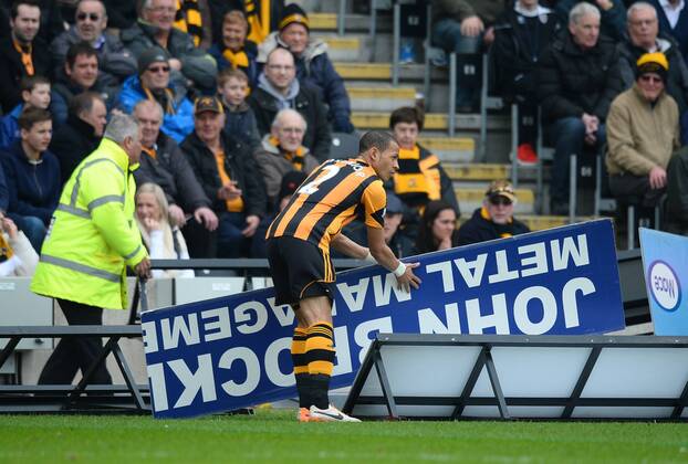 Liam Rosenior of Hull City removes an ad board that had blown onto the pitch - Barclays Premier League - Hull City v Arsenal - KC Stadium - Hull - England - 20th April 2014 - Pic Simon Bellis Sportimage EDITORIAL USE ONLY. No use with unauthorised audio, video, data, fixture lists, club league logos or live services. Online in-match use limited to 120 images, no video emulation. No use in betting, games or single club league player publications.