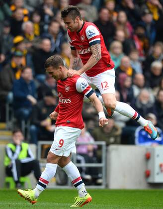 Scorer Lucas Podolski of Arsenal is jumped on by Olivier Giroud of Arsenal - Barclays Premier League - Hull City v Arsenal - KC Stadium - Hull - England - 20th April 2014 - Pic Simon Bellis Sportimage EDITORIAL USE ONLY. No use with unauthorised audio, video, data, fixture lists, club league logos or live services. Online in-match use limited to 120 images, no video emulation. No use in betting, games or single club league player publications.