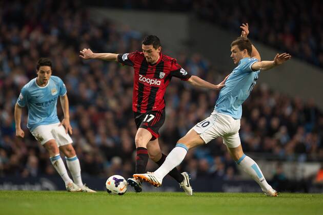 Edin Dzeko of Manchester City challenges West Brom s Graham Dorrans - Barclays Premier League - Manchester City vs. West Bromwich Albion - Etihad Stadium - Manchester - England - 21st April 2014 - Pic by Philip Oldham SportImage EDITORIAL USE ONLY. No use with unauthorised audio, video, data, fixture lists, club league logos or live services. Online in-match use limited to 120 images, no video emulation. No use in betting, games or single club league player publications.