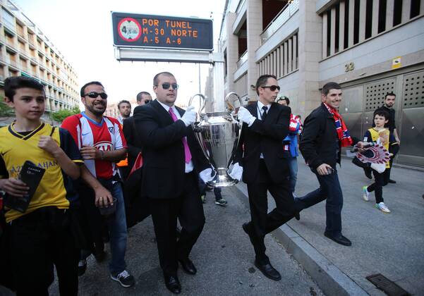2 security guards parade the Champions League trophy outside the stadium - Champions League, SemiFinal, First leg - Vicente Calderon Stadium, home of Atletico Madrid - 22 04 2014 - EDITORIAL USE ONLY. No use with unauthorised audio, video, data, fixture lists, club league logos or live services. Online in-match use limited to 120 images, no video emulation. No use in betting, games or single club league player publications.