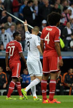 Real Madrid Forward, number 9 BENZEMA - Karim Benzema (25), celebrates after scoring a goal (1-0)FC Bayern Munchen Defender, number 4 DANTE - Dante Bonfim Costa Santos (29), FC Bayern Munchen Midfielder, number 27 ALABA - David Alaba (20) during round Semifinal of the Champions League league, soccer match between Real Madrid - FC Bayern Munich at the Santiago Bernabeu estadium, Madrid - Spain by April 23, 2014. 
