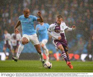 Vincent Kompany of Manchester City tussles with Andreas Weimann of Aston Villa - Barclays Premier League - Manchester City v Aston Villa - Etihad Stadium - Manchester - England - 7th May 2014 - Pic Simon Bellis Sportimage EDITORIAL USE ONLY. No use with unauthorised audio, video, data, fixture lists, club league logos or live services. Online in-match use limited to 120 images, no video emulation. No use in betting, games or single club league player publications.