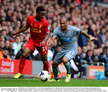 Raheem Sterling of Liverpool challenged by Yoan Gouffran of Newcastle United - Barclays Premier League - Liverpool FC vs Newcastle United - Anfield Stadium - Liverpool - England - 11th May 2014 - EDITORIAL USE ONLY. No use with unauthorised audio, video, data, fixture lists, club league logos or live services. Online in-match use limited to 120 images, no video emulation. No use in betting, games or single club league player publications.