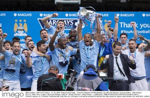 Vincent Kompany of Manchester City lifts the Premier League trophy - Manchester City vs. West Ham United - Barclays Premier League - Etihad Stadium - Manchester - 11 05 2014 EDITORIAL USE ONLY. No use with unauthorised audio, video, data, fixture lists, club league logos or live services. Online in-match use limited to 120 images, no video emulation. No use in betting, games or single club league player publications.