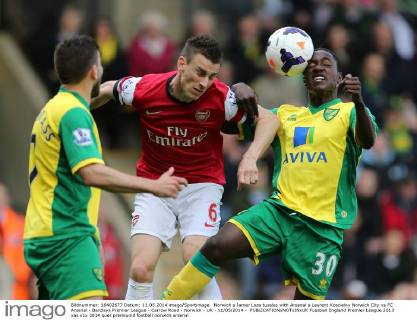 Norwich s Jamar Loza tussles with Arsenal s Laurent Koscielny Norwich City vs FC Arsenal - Barclays Premier League - Carrow Road - Norwich - UK - 11 05 2014 - EDITORIAL USE ONLY. No use with unauthorised audio, video, data, fixture lists, club league logos or live services. Online in-match use limited to 120 images, no video emulation. No use in betting, games or single club league player publications.