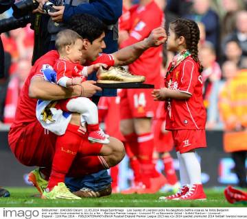 Luis Suarez of Liverpool picks his daughters Delfina nose as he holds Benjamin and a golden boot presented to him by a fan - Barclays Premier League - Liverpool FC vs Newcastle United - Anfield Stadium - Liverpool - England - 11th May 2014 - EDITORIAL USE ONLY. No use with unauthorised audio, video, data, fixture lists, club league logos or live services. Online in-match use limited to 120 images, no video emulation. No use in betting, games or single club league player publications.