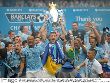 Football - 2013 2014 Premier League - Manchester City vs. West Ham United Manchester City s Edin Dzeko lifts the Barclays Premier League trophy following his teams win at the Etihad Stadium, Manchester 