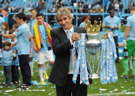 Football - 2013 2014 Premier League - Manchester City vs. West Ham United Manchester City s manager Manuel Pellegrini holds the Barclays Premier League trophy at the Etihad Stadium, Manchester 