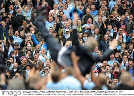 Football - 2013 2014 Premier League - Manchester City vs. West Ham United Manuel Pellegrini Manager of Manchester City is thrown in the air by his team as they celebrate winning the Barclays Premier League at the Etihad Stadium, Manchester 