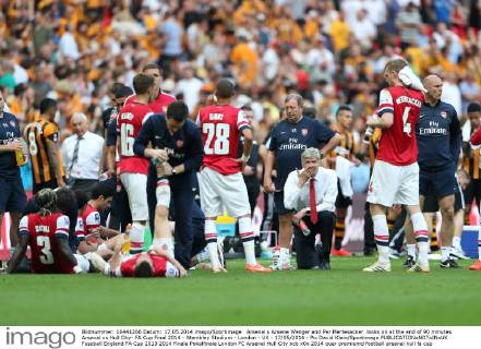 Arsenal s Arsene Wenger and Per Mertesacker looks on at the end of 90 minutes Arsenal vs Hull City- FA Cup Final 2014 - Wembley Stadium - London - UK - 17 05 2014 - Pic David Klein Sportimage EDITORIAL USE ONLY. No use with unauthorised audio, video, data, fixture lists, club league logos or live services. Online in-match use limited to 120 images, no video emulation. No use in betting, games or single club league player publications.