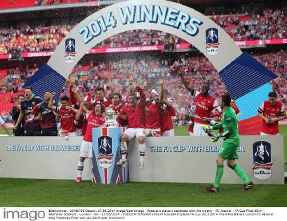 Arsenal s players celebrate with the trophy - FC Arsenal - FA Cup Final 2014 - Wembley Stadium - London - UK - 17 05 2014 - EDITORIAL USE ONLY. No use with unauthorised audio, video, data, fixture lists, club league logos or live services. Online in-match use limited to 120 images, no video emulation. No use in betting, games or single club league player publications.