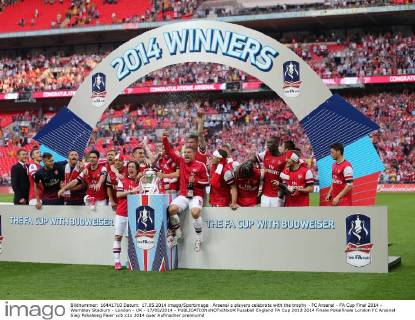 Arsenal s players celebrate with the trophy - FC Arsenal - FA Cup Final 2014 - Wembley Stadium - London - UK - 17 05 2014 - EDITORIAL USE ONLY. No use with unauthorised audio, video, data, fixture lists, club league logos or live services. Online in-match use limited to 120 images, no video emulation. No use in betting, games or single club league player publications.
