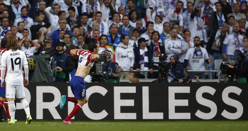 Diego Godin (Atletico Madrid 2) celebrating his goal, Real fans are disappointed in the fanblock during the final of the Champions league between Real Madrid and Atletico Madrid, Estadio da Luz in Lisbon on May 24., 2014. Real Madrid gegen Atletico Madrid im Finale der Champions League, Saison 2013 2014 am 24. Mai 2014.