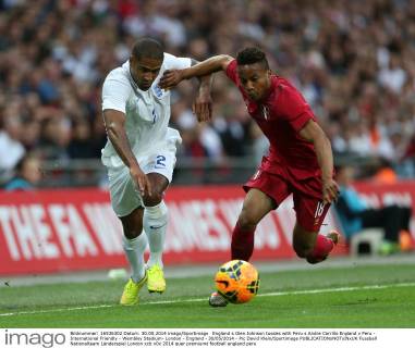 England s Glen Johnson tussles with Peru s Andre Carrillo England v Peru - International Friendly - Wembley Stadium- London - England - 30 05 2014 - Pic David Klein Sportimage EDITORIAL USE ONLY. No use with unauthorised audio, video, data, fixture lists, club league logos or live services. Online in-match use limited to 120 images, no video emulation. No use in betting, games or single club league player publications.