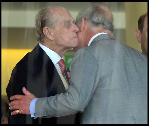 Image ©Licensed to i-Images Picture Agency. 18 06 2014. Ascot, United Kingdom. The Duke of Edinburgh kisses his son The Prince of Wales in the Royal Box on Day 2 of Royal Ascot at Ascot Racecourse. Picture by Andrew Parsons i-Images AndrewxParsonsx xi-Images IIM-2483-0035