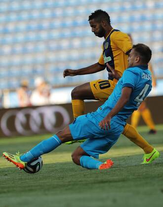 ITAR-TASS: ST. PETERSBURG, RUSSIA. AUGUST 6, 2014. AEL s Diego Barcelos (background) and Zenit s Domenico Criscito fight for the ball in their UEFA Champions League 3rd Qualifying Round match at the Petrovsky Stadium in St. Petersburg. FC Zenit St Petersburg wins the game 3:0.  premiumd 20211412