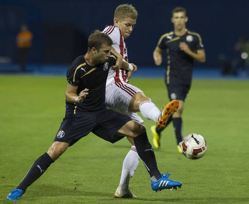 Domagoj Antolic of Dinamo Zagreb (L) vies with Mathias Wichmann of Aalborg during UEFA Champions League 3rd Qualifying Round soccer match at the Maksimir Stadium in Zagreb, Croatia, Aug. 6, 2014. Aalborg won 2-0.) (SP)CROATIA-ZAGREB-UEFA CHAMPIONS LEAGUE QUALIFYING MATCH MisoxLisanin 