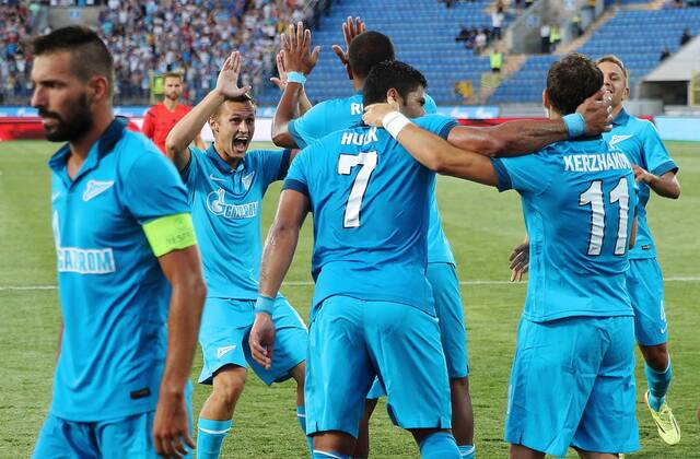 ITAR-TASS: ST. PETERSBURG, RUSSIA. AUGUST 6, 2014. Zenit s players celebrate scoring in their second leg of the 2014 15 Season UEFA Champions League Third Qualifiying Round football match against AEL Limassol at Petrovsky Stadium. FC Zenit won the game 3:0.  RE14C506