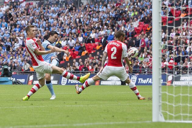 Samir Nasri of Manchester City fires a shot at goal but has it deflected - Arsenal vs. Manchester City - The FA Community Shield - Wembley Stadium - London - 10 08 2014 Pic Philip Oldham Sportimage EDITORIAL USE ONLY. No use with unauthorised audio, video, data, fixture lists, club league logos or live services. Online in-match use limited to 120 images, no video emulation. No use in betting, games or single club league player publications.