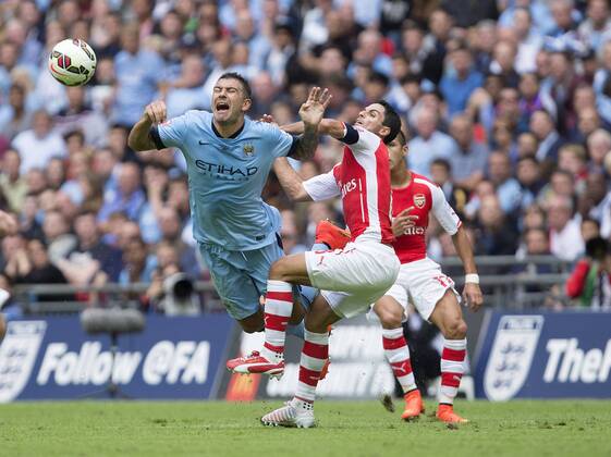 Arsenal s Mikel Arteta challenges Aleksander Kolorov of Manchester City - Arsenal vs. Manchester City - The FA Community Shield - Wembley Stadium - London - 10 08 2014 Pic Philip Oldham Sportimage EDITORIAL USE ONLY. No use with unauthorised audio, video, data, fixture lists, club league logos or live services. Online in-match use limited to 120 images, no video emulation. No use in betting, games or single club league player publications.