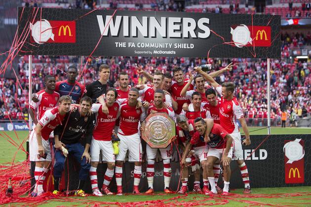 Arsenal celebrate with the Community Shield - Arsenal vs. Manchester City - The FA Community Shield - Wembley Stadium - London - 10 08 2014 EDITORIAL USE ONLY. No use with unauthorised audio, video, data, fixture lists, club league logos or live services. Online in-match use limited to 120 images, no video emulation. No use in betting, games or single club league player publications.