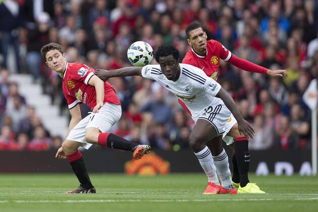 Ander Herrera and Chris Smalling of Manchester United defend against Swansea s Wilfried Bony Manchester United ManU - Swansea City - Barclays Premier League - Old Trafford - Manchester - 16 08 2014 EDITORIAL USE ONLY. No use with unauthorised audio, video, data, fixture lists, club league logos or live services. Online in-match use limited to 120 images, no video emulation. No use in betting, games or single club league player publications.