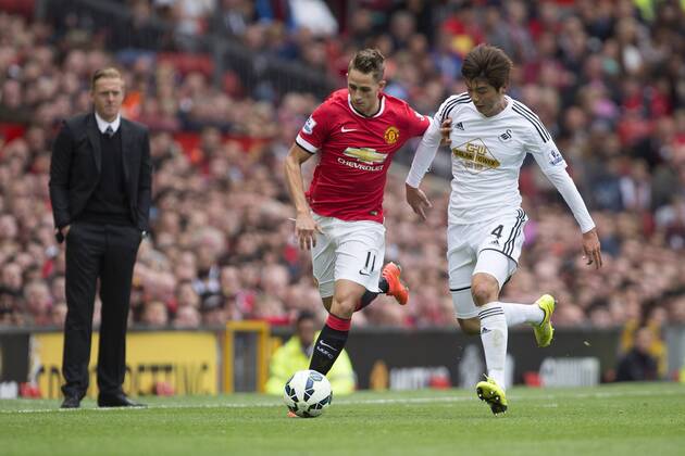 Adnan Januzaj of Manchester United and Swansea s Ki Sung-yueng battle Manchester United ManU - Swansea City - Barclays Premier League - Old Trafford - Manchester - 16 08 2014 EDITORIAL USE ONLY. No use with unauthorised audio, video, data, fixture lists, club league logos or live services. Online in-match use limited to 120 images, no video emulation. No use in betting, games or single club league player publications.