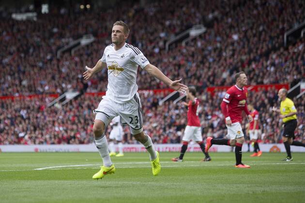 Swansea s Gylfi Sigurdsson celebrates scoring his sides second goal - Manchester United vs. Swansea - Barclays Premier League - Old Trafford - Manchester - 16 08 2014 Pic Philip Oldham Sportimage EDITORIAL USE ONLY. No use with unauthorised audio, video, data, fixture lists, club league logos or live services. Online in-match use limited to 120 images, no video emulation. No use in betting, games or single club league player publications.