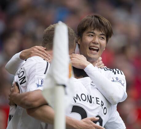 Swansea s Gylfi Sigurdsson celebrates scoring his sides second goal with fellow goal scorer Ki Sung-yueng - Manchester United vs. Swansea - Barclays Premier League - Old Trafford - Manchester - 16 08 2014 Pic Philip Oldham Sportimage EDITORIAL USE ONLY. No use with unauthorised audio, video, data, fixture lists, club league logos or live services. Online in-match use limited to 120 images, no video emulation. No use in betting, games or single club league player publications.