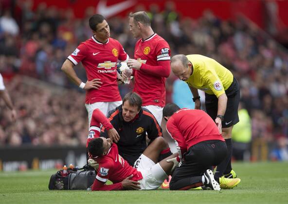 Jesse Lingaard of Manchester United in pain following a challenge - Manchester United vs. Swansea - Barclays Premier League - Old Trafford - Manchester - 16 08 2014 Pic Philip Oldham Sportimage EDITORIAL USE ONLY. No use with unauthorised audio, video, data, fixture lists, club league logos or live services. Online in-match use limited to 120 images, no video emulation. No use in betting, games or single club league player publications.