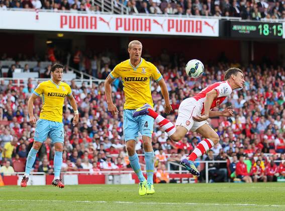 Arsenal s Laurent Koscielny scoring his sides opening goal - Barclays Premier League - Arsenal vs Crystal Palace - Emirates Stadium - London - England - 16th August 2014 - Picture David Klein Sportimage EDITORIAL USE ONLY. No use with unauthorised audio, video, data, fixture lists, club league logos or live services. Online in-match use limited to 120 images, no video emulation. No use in betting, games or single club league player publications.