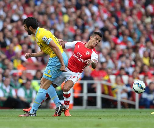 Arsenal s Alexis Sanchez tussles with Crystal Palace s Mile Jedinak - Barclays Premier League - Arsenal vs Crystal Palace - Emirates Stadium - London - England - 16th August 2014 - Picture David Klein Sportimage EDITORIAL USE ONLY. No use with unauthorised audio, video, data, fixture lists, club league logos or live services. Online in-match use limited to 120 images, no video emulation. No use in betting, games or single club league player publications.