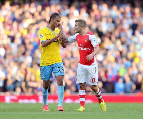 Arsenal s Jack Wilshere slaps Crystal Palace s Marouane Chamakh - Barclays Premier League - Arsenal FC vs Crystal Palace - Emirates Stadium - London - England - 16th August 2014 - Picture David Klein Sportimage EDITORIAL USE ONLY. No use with unauthorised audio, video, data, fixture lists, club league logos or live services. Online in-match use limited to 120 images, no video emulation. No use in betting, games or single club league player publications.