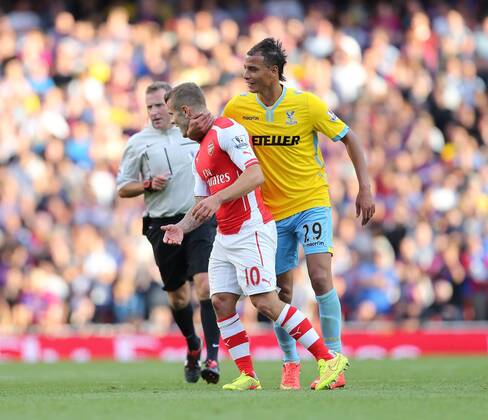 Arsenal s Jack Wilshere slaps Crystal Palace s Marouane Chamakh who gets him in a headlock - Barclays Premier League - Arsenal FC vs Crystal Palace - Emirates Stadium - London - England - 16th August 2014 - Picture David Klein Sportimage EDITORIAL USE ONLY. No use with unauthorised audio, video, data, fixture lists, club league logos or live services. Online in-match use limited to 120 images, no video emulation. No use in betting, games or single club league player publications.
