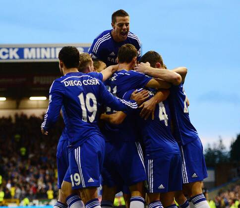 Branislav Ivanovic of Chelsea is mobbed celebrating the third goal - Barclays Premier League - Burnley vs Chelsea - Turf Moor Stadium - Burnley - England - 18th August 2014 - Pic Simon Bellis Sportimage EDITORIAL USE ONLY. No use with unauthorised audio, video, data, fixture lists, club league logos or live services. Online in-match use limited to 120 images, no video emulation. No use in betting, games or single club league player publications.