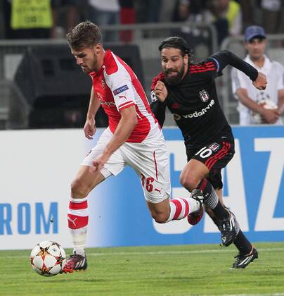 UEFA Champions League playoff first leg match match between Besiktas and Arsenal at Olympic stadium in istanbul 19 august 2014. Pictured: Aaron Ramsey of Arsenal and Olcay Sahan of Besiktas (R) 