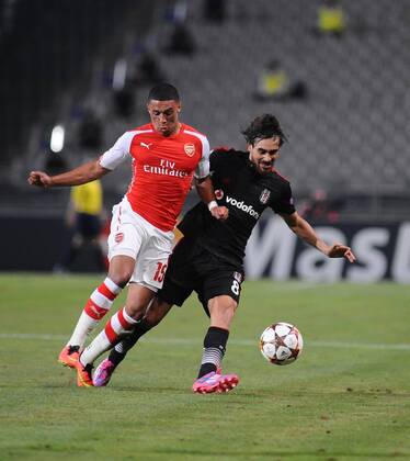 UEFA Champions League playoff first leg match match between Besiktas and Arsenal at Olympic stadium in istanbul 19 august 2014. Score: Besiktas 0 - Arsenal 0 Pictured: Alexander (Alex) Mark David Oxlade Chamberlain of Arsenal and Veli Kavlak of Besiktas.