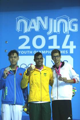 (140822) -- NANJING, Aug 22, 2014 -- Gold medalist Matheus Paulo de Santana of Brazil(C) and silver medalist Yu Hexin(R)of China and Bronze medalist Damian Wierling of Germany react during the awarding ceremony after the Men s 100m Freestyle match at Nanjing 2014 Youth Olympic Games in Nanjing, capital of east China s Jiangsu Province, on Aug. 22, 2014.)(hhx) (SP)YOG-CHINA-NANJING-ATHLETICS FeixMaohua 