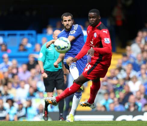 Chelsea s Cesc Fabregas tussle with Leicester s Jeff Schlupp - Barclays Premier League - FC Chelsea vs Leicester City - Stamford Bridge - London - England - 23rd August 2014 - Picture David Klein Sportimage EDITORIAL USE ONLY. No use with unauthorised audio, video, data, fixture lists, club league logos or live services. Online in-match use limited to 120 images, no video emulation. No use in betting, games or single club league player publications.