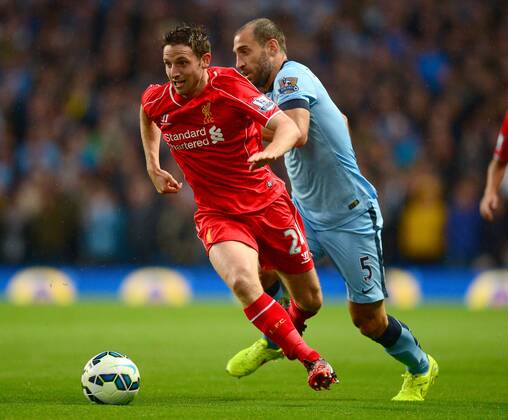 Joe Allen of Liverpool skips past Pablo Zabaleta of Manchester City - Barclays Premier League - Manchester City vs Liverpool - Etihad Stadium - Manchester - England - 25th August 2014 - Pic Simon Bellis Sportimage EDITORIAL USE ONLY. No use with unauthorised audio, video, data, fixture lists, club league logos or live services. Online in-match use limited to 120 images, no video emulation. No use in betting, games or single club league player publications.