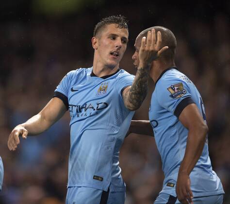 Stevan Jovetic of Manchester City celebrates his opening goal with Fernando - Manchester City vs. Liverpool - Barclays Premier League - Etihad Stadium - Manchester - 25 08 2014 Pic Philip Oldham Sportimage EDITORIAL USE ONLY. No use with unauthorised audio, video, data, fixture lists, club league logos or live services. Online in-match use limited to 120 images, no video emulation. No use in betting, games or single club league player publications.